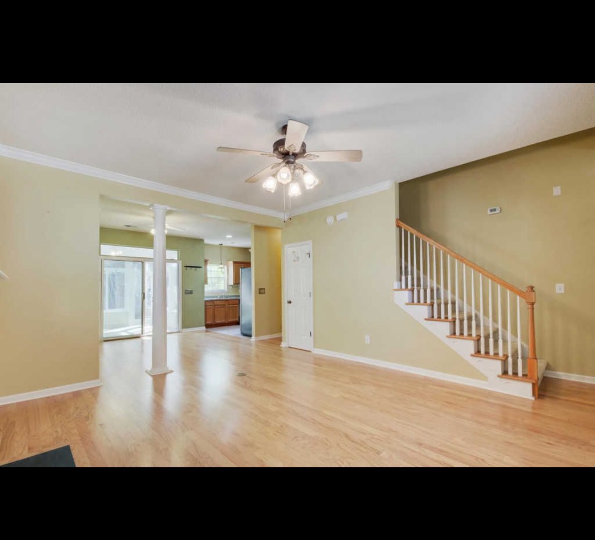 Living room before, pillar visible between dining and living areas
